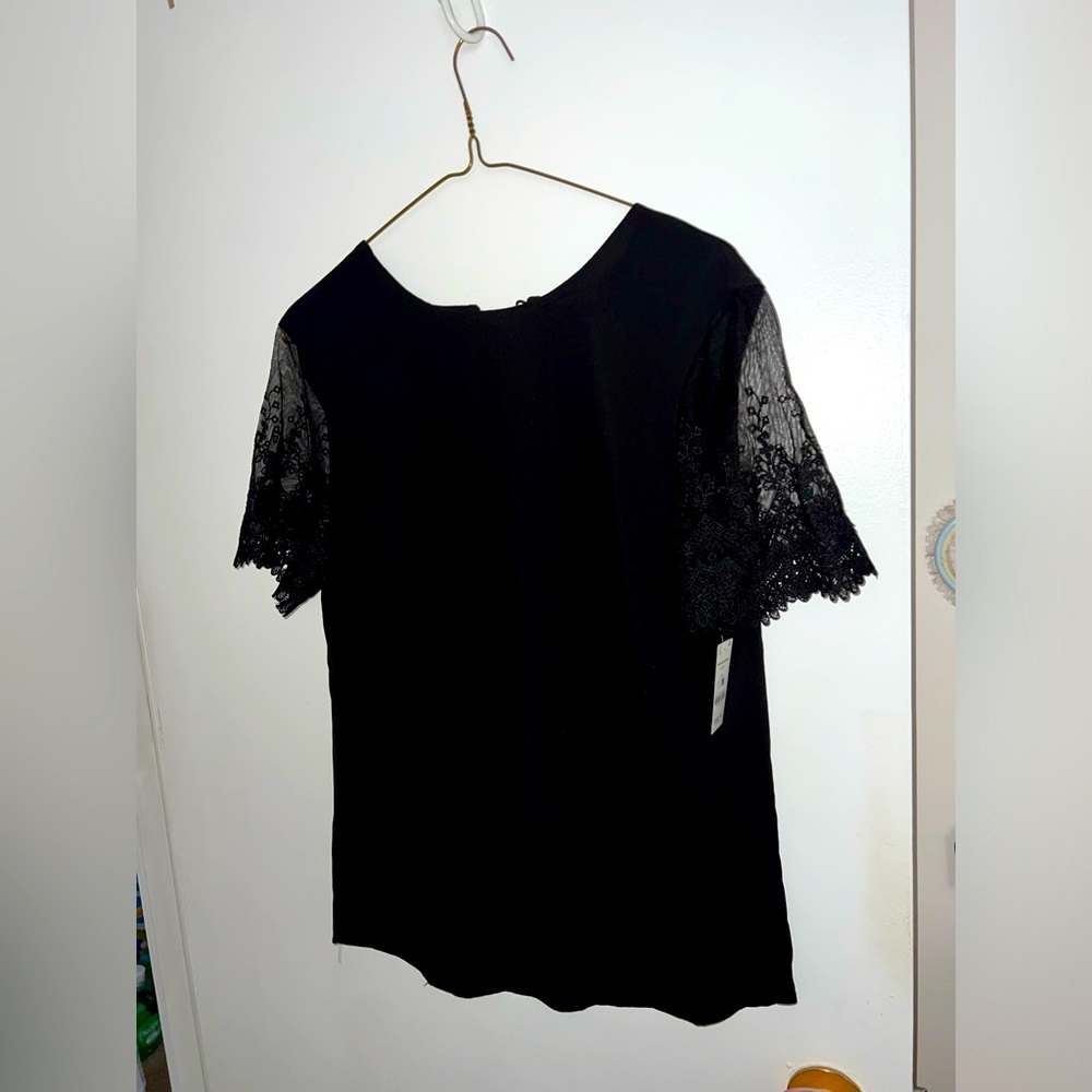 Black top with lace short sleeves. Single button closer at the back.